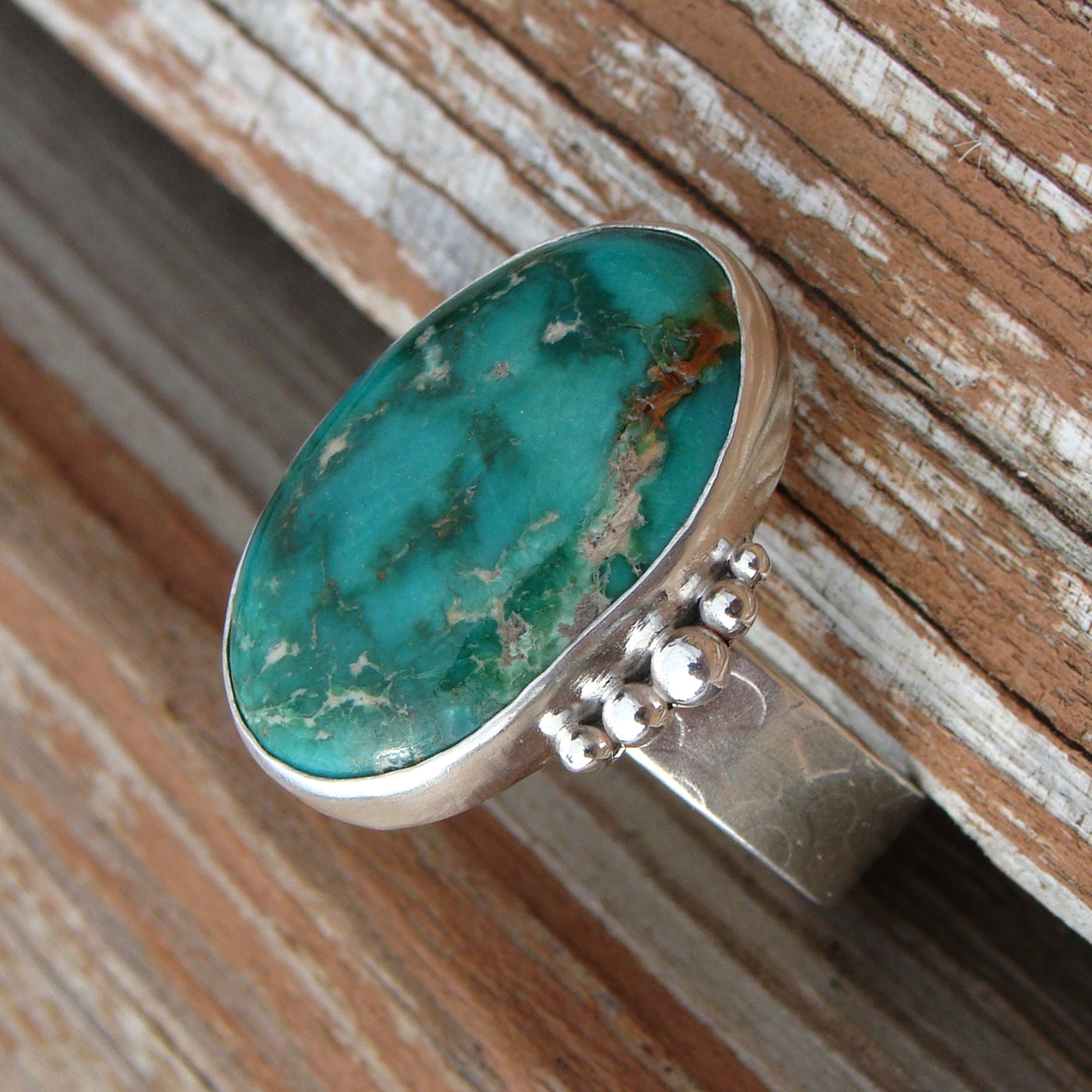 fox mine turquoise ring on wood - side view