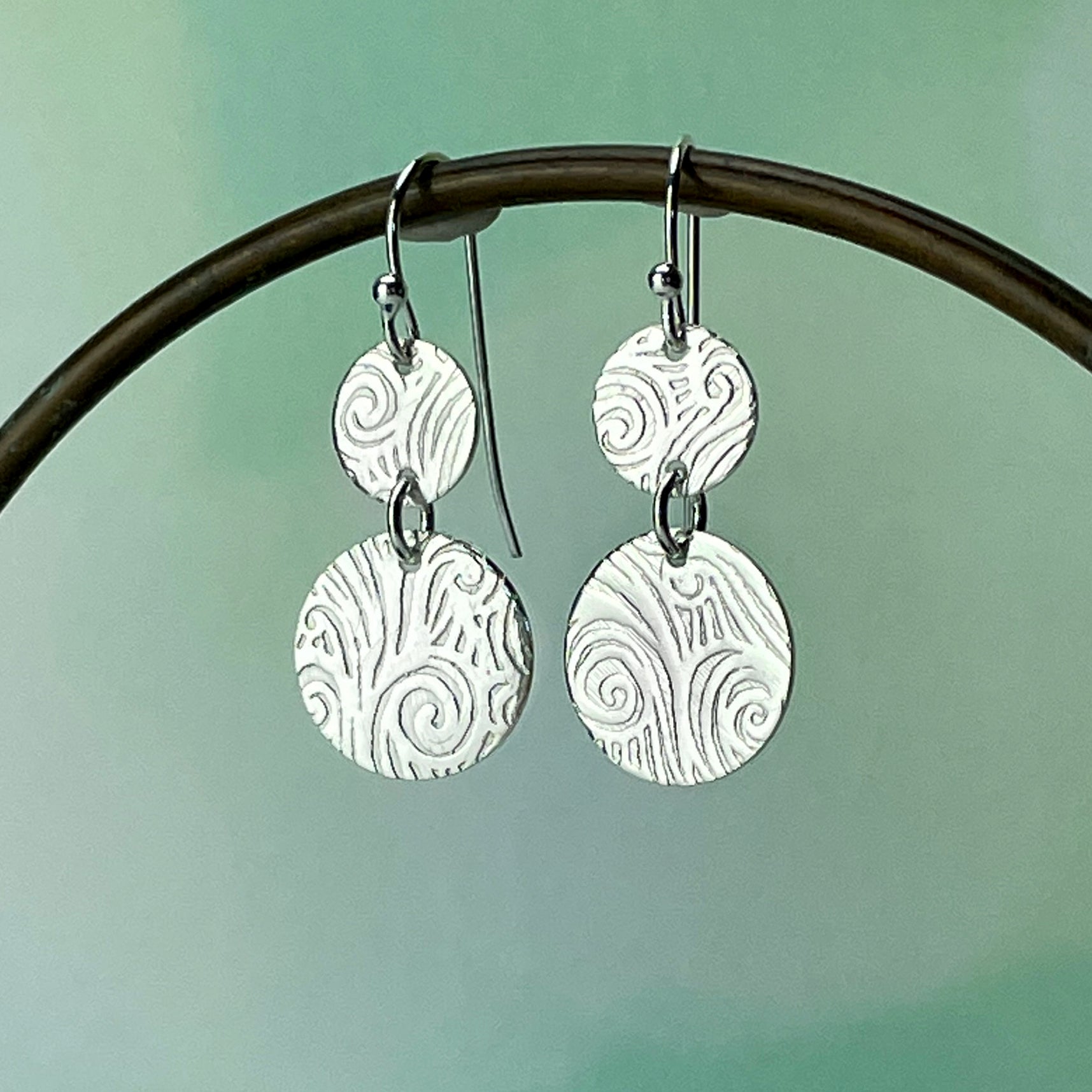 round cascade swirl earrings on prop