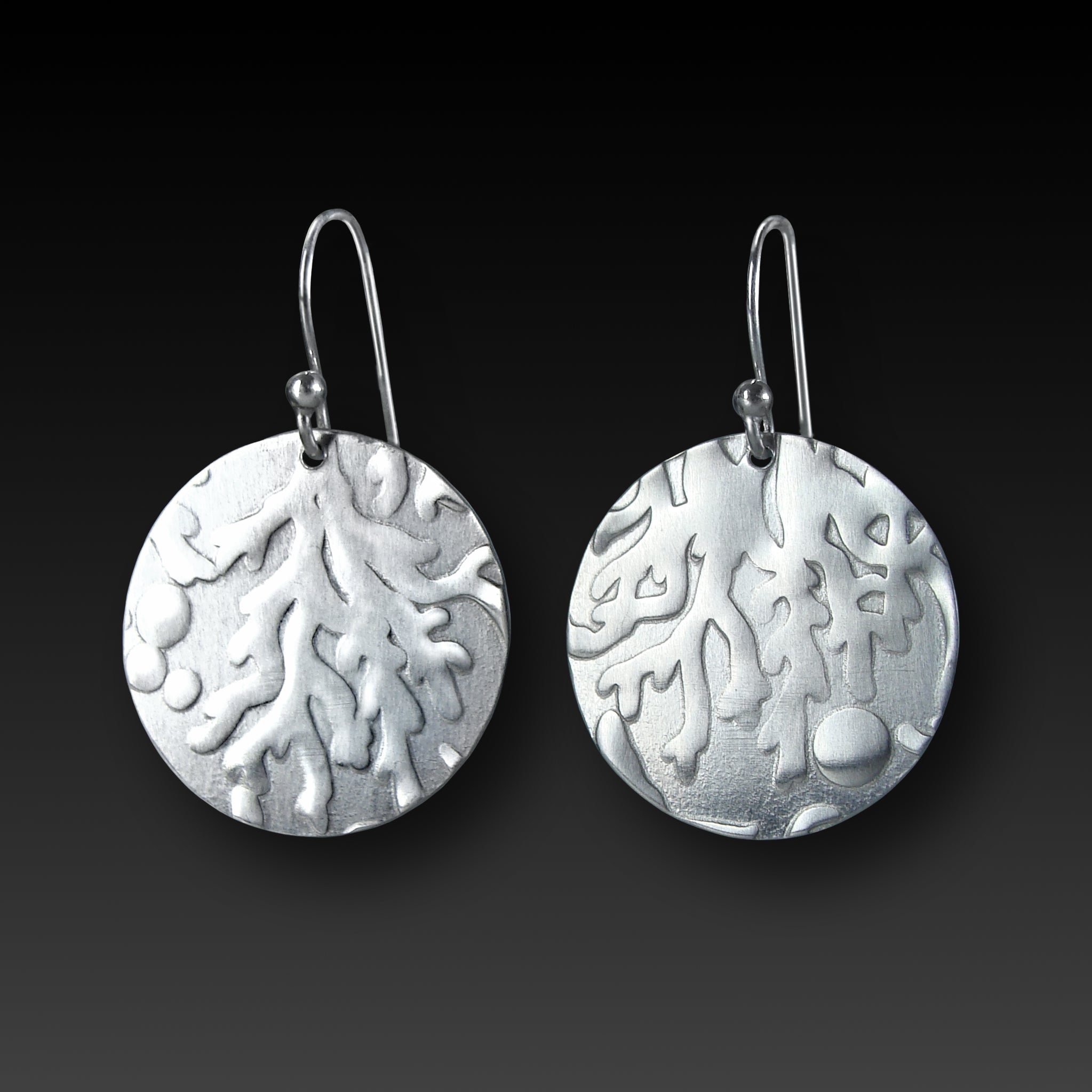 silver round earrings with coral texture on gradient background